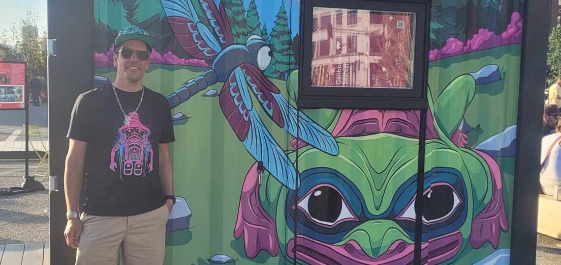 Artist standing in front of frog mural