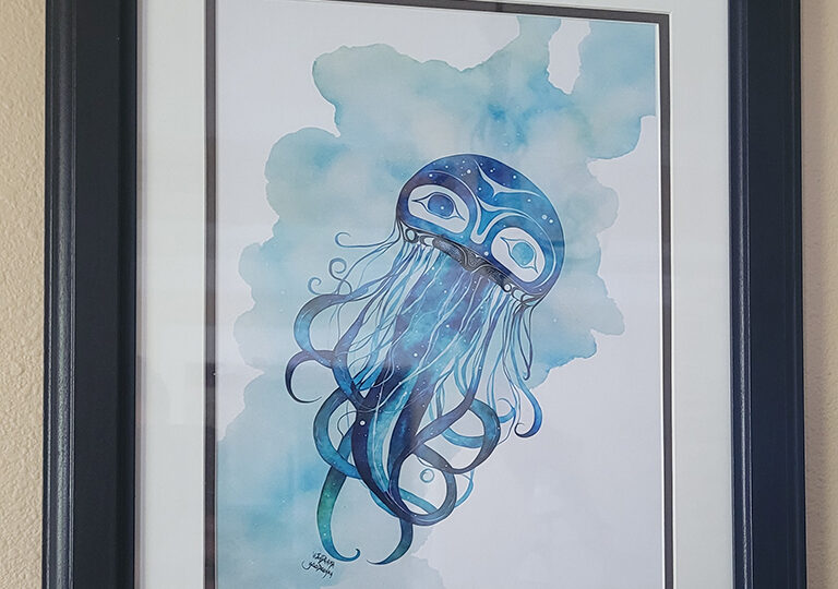 Photo of a framed watercolor print of a blue and green Tlingit jellyfish