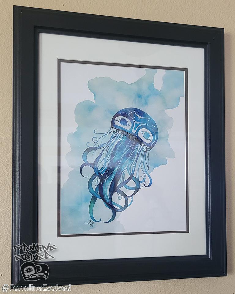 Photo of a framed watercolor print of a blue and green Tlingit jellyfish